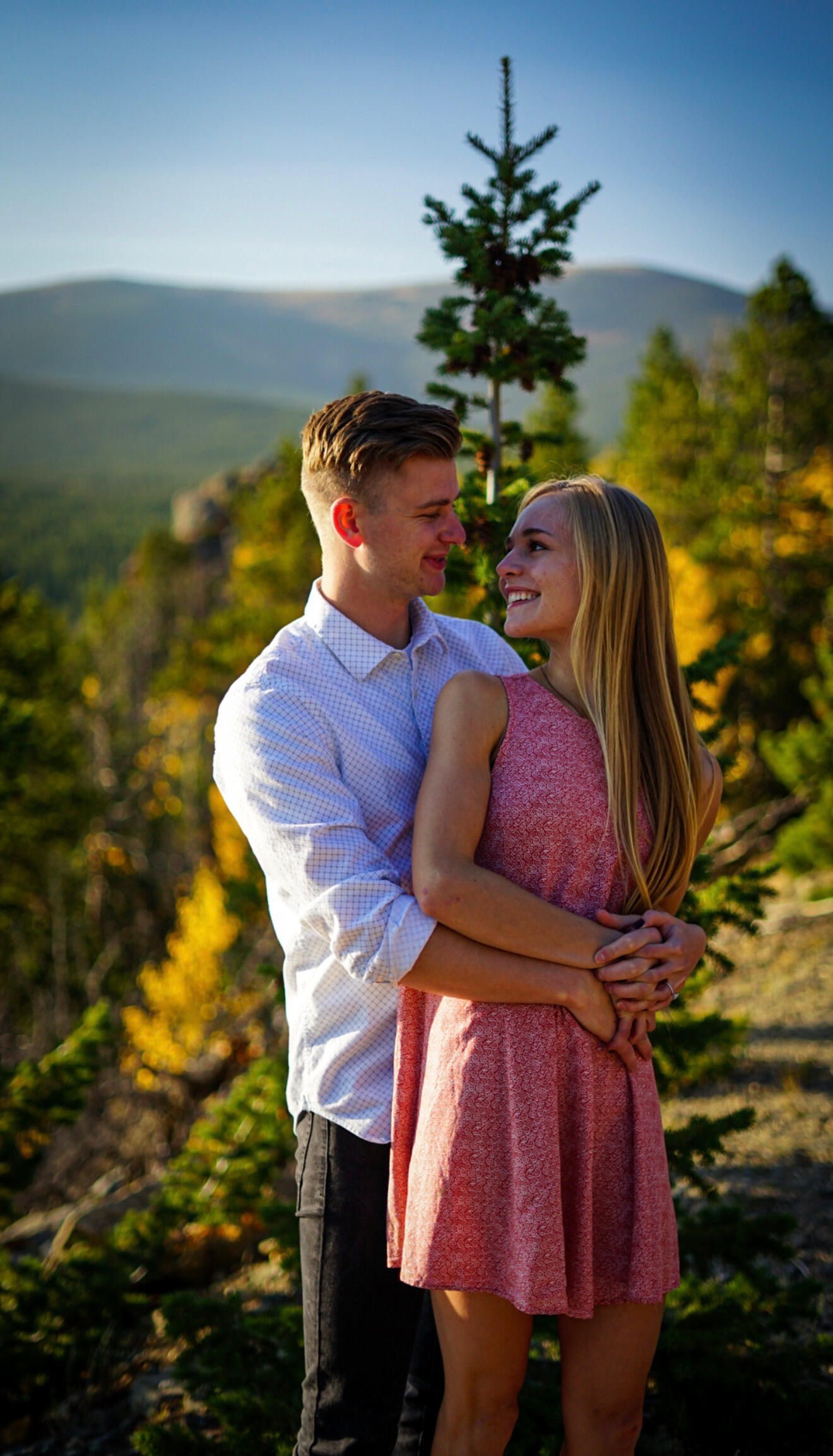 Untitled Couple under autumn trees with mountains near Flagstaff